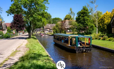 Canal large bordé de roseaux dans le Parc National Weerribben-Wieden vu lors de l'excursion en bateau à Giethoorn
