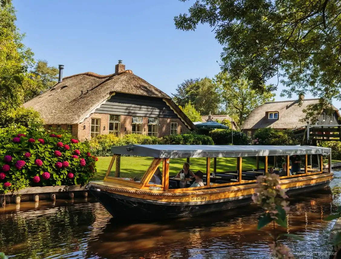 Wooden bridge over a Giethoorn canal seen on the Amsterdam day trip