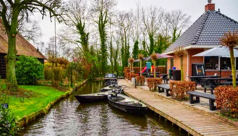 Wooden arch bridge over a canal in Giethoorn village